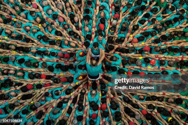 Members of the colla Castellers de Vilafranca build a human tower during the 27th Concurs de Castells competition on October 7, 2018 in Tarragona,...