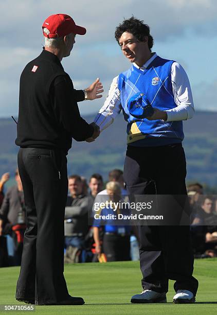 Rory McIlroy of Europe shakes hands with USA Captain Corey Pavin on the 18th green after he halved his match in the singles matches during the 2010...