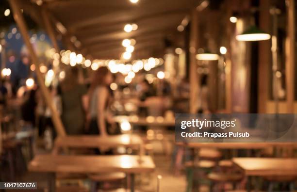 blurred background of restaurant with people. - goldbarren stockfoto's en -beelden