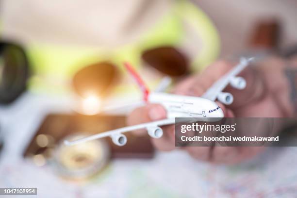 model aircraft with neutral passport and map background - cancel stock pictures, royalty-free photos & images