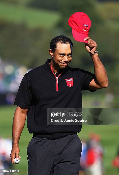 Tiger Woods of the USA acknowledges the crowd after holing out for an eagle on the 12th hole in the singles matches during the 2010 Ryder Cup at the...