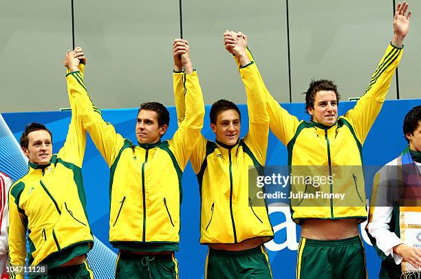 Kyle Richardson, Eamon Sullivan, Tommaso D'orsogna and James Magnussen of Australia celebrate prior receiving their gold medals during the medal...