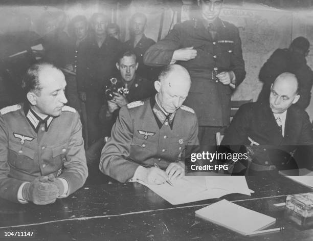 Nazi chief of staff General Gustaf Jodl signing the unconditional surrender of the Wehrmacht to end World War II, in Rheims, France, circa 1945.