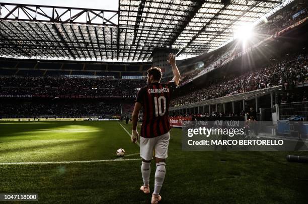 Milan's Turkish midfielder Hakan Calhanoglu gestures during the Italian Serie A football match between AC Milan and Chievo Verona on October 7, 2018...