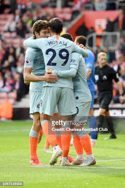 Alvaro Morata of Chelsea celebrates with teammates Eden Hazard and Marcos Alonso after scoring his team's third goal during the Premier League match...