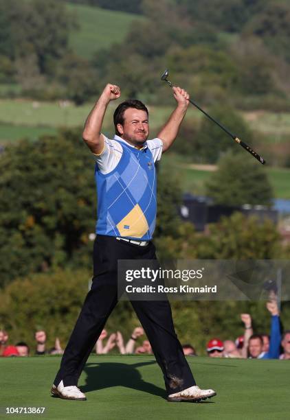 Graeme McDowell of Europe celebrates his 3&1 win to secure victory for the European team on the 17th green in the singles matches during the 2010...