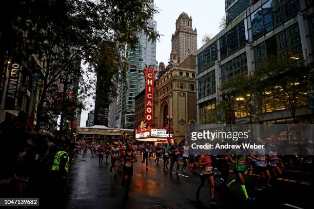 Runners pass the Chicago Theater during the 2018 Bank of America Chicago Marathon on October 7, 2018 in Chicago, Illinois.