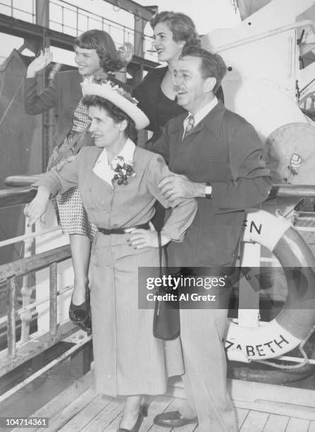 Walt Disney , American film producer, director, screenwriter, voice actor and animator, with his wife Lillian Disney and their two daughters, Sharon...