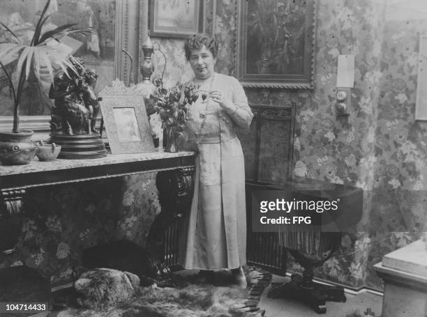 Baroness Emma Magdolna Rozalia Maria Jozefa Borbala Emmuska Orczy de Orczi , British novelist and playwright, pictured in her study arranging a vase...