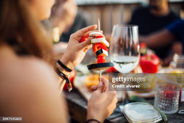 woman preparing skewers with food - rooftop bbq stock pictures, royalty-free photos & images