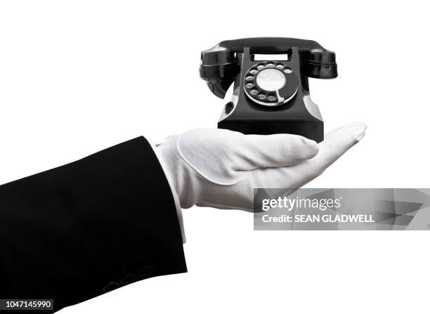 butler holding black vintage telephone - white glove phone stock pictures, royalty-free photos & images