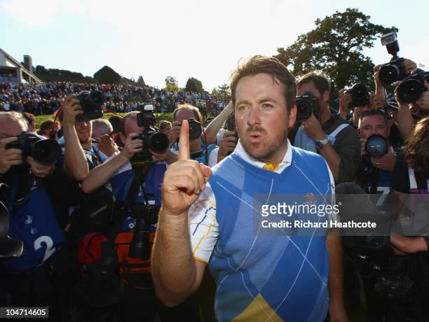 Graeme McDowell of Europe celebrates his 3&1 win to secure victory for the European team on the 17th green in the singles matches during the 2010...