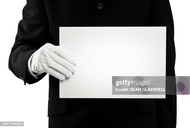 chauffeur holding blank card - paire de gants noirs photos et images de collection