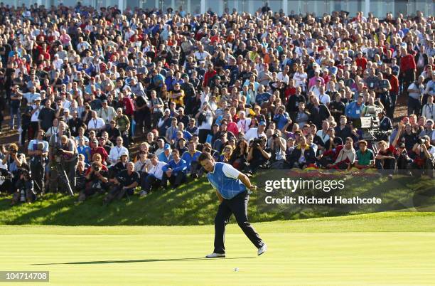 Graeme McDowell of Europe watches his putt on the 16th green in the singles matches during the 2010 Ryder Cup at the Celtic Manor Resort on October...