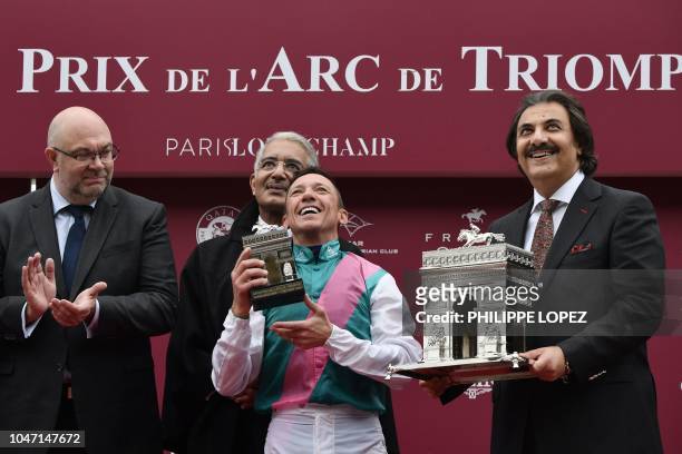 Italian jockey Frankie Dettori , flanked by French Agriculture Minister Stephane Travert and Qatari Sheikh Abdullah Bin Khalifa Al Thani , celebrates...