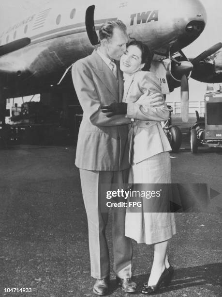 Kelton 'Tex' Ritter greeting his wife, Joy Slade Ritter, on her arrival at New York International Airport, New York, USA, 3 April 1952. Kelton...