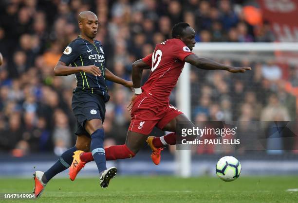 Manchester City's Brazilian midfielder Fernandinho fouls Liverpool's Senegalese striker Sadio Mane during the English Premier League football match...