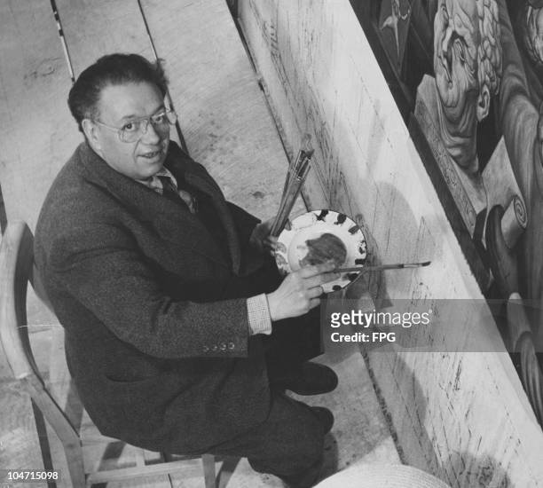 Diego Rivera , Mexican artist, finishing a mural in the lobby of the Cordiac Institute, Mexico City, Mexico, circa 1930.