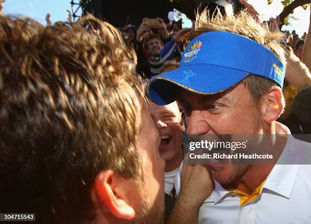 Graeme McDowell of Europe celebrates his 3&1 win to secure victory for the European team on the 17th green with Ian Poulter in the singles matches...