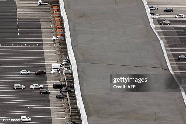 An aerial view shows cars arriving at the Saint-Arnoult tollbooth, outside Paris on September 16, 2010. AFP PHOTO JOEL SAGET