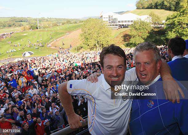 European Team captain Colin Montgomerie of Europe poses with Graeme McDowell on the balcony of the clubhouse following Europe's victory during the...