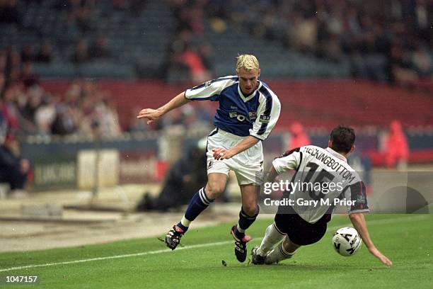 David Farrell of Peterborough runs past Paul Heckingbottom of Darlington during the Division 3 Play-off Final at Wembley, London. Peterborough won...