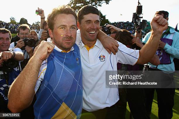 Graeme McDowell and Padraig Harrington of Europe celebrate following Europe's victory in the 2010 Ryder Cup at the Celtic Manor Resort on October 4,...