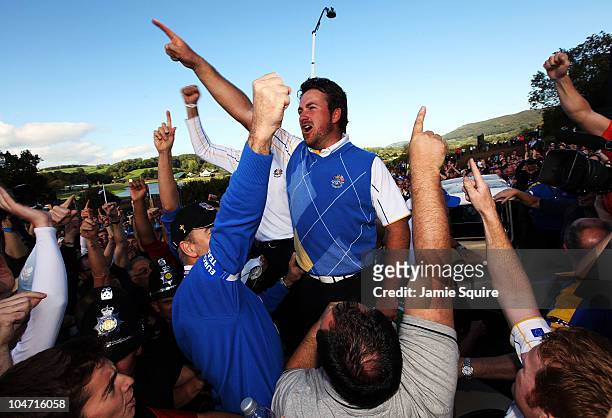 Graeme McDowell of Europe celebrates his 3&1 win to secure victory for the European team on the 17th green at the end of the singles matches during...