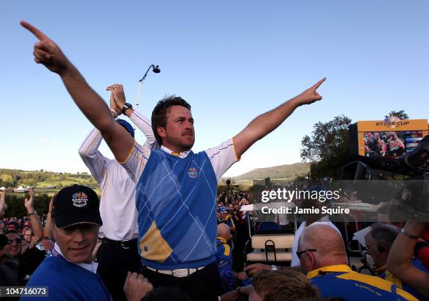 Graeme McDowell of Europe celebrates his 3&1 win to secure victory for the European team on the 17th green at the end of the singles matches during...