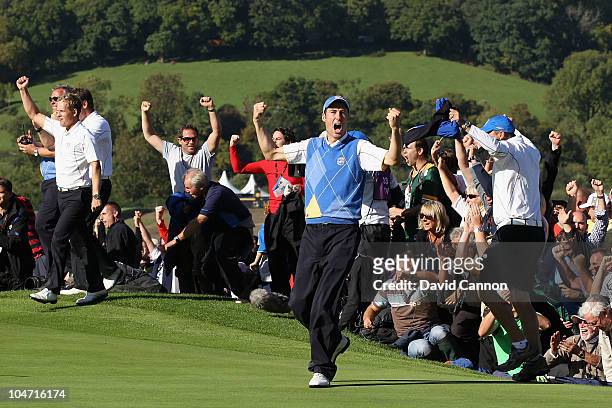 Ross Fisher of Europe celebrates with his team on the 17th green after victory by the European in the singles matches during the 2010 Ryder Cup at...