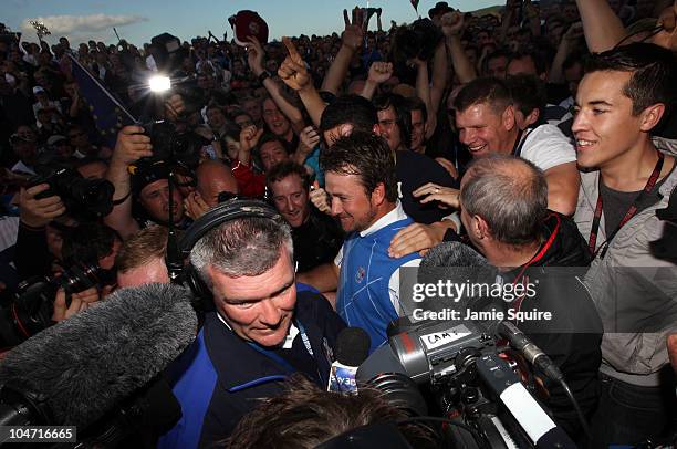 Graeme McDowell of Europe celebrates his 3&1 win to secure victory for the European team on the 17th green at the end of the singles matches during...