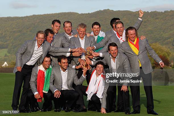 European Team Captain Colin Montgomerie poses with the Ryder Cup and his team following Europe's 14.5 to 13.5 victory over the USA at the 2010 Ryder...