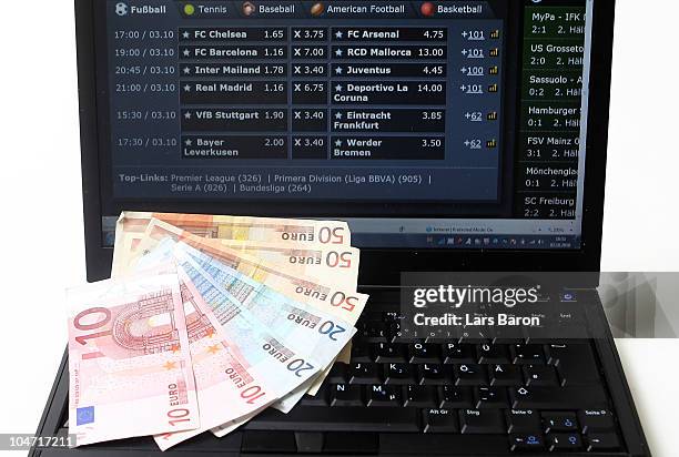 This photo illustration shows a laptop signing an internet betting webpage together with Euro bank notes on October 2, 2010 in Dinslaken, Germany....