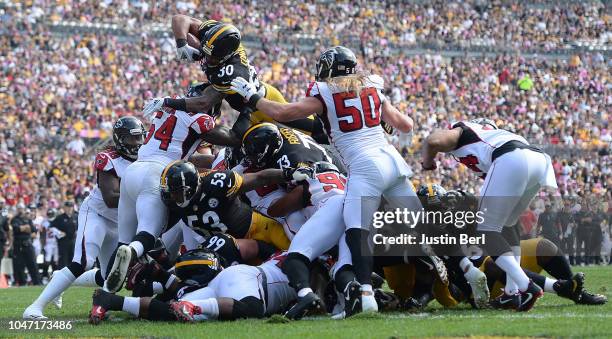 James Conner of the Pittsburgh Steelers dives into the end zone for a 1 yard touchdown in the first quarter during the game against the Atlanta...