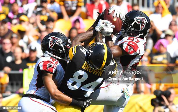 Damontae Kazee of the Atlanta Falcons intercepts a pass intended for Antonio Brown of the Pittsburgh Steelers in the end zone during the first half...
