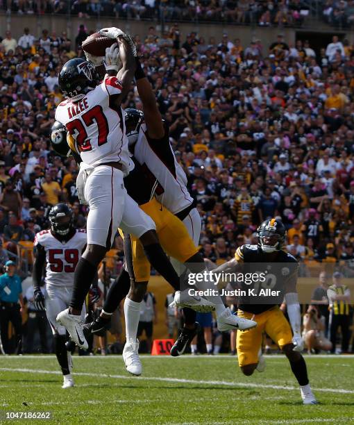 Damontae Kazee of the Atlanta Falcons intercepts a pass intended for Antonio Brown of the Pittsburgh Steelers in the end zone during the first half...