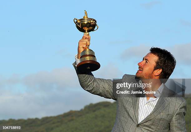 European Team member Graeme McDowell poses with the Ryder Cup following Europe's 14.5 to 13.5 victory over the USA at the 2010 Ryder Cup at the...