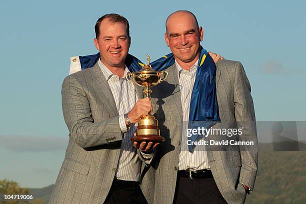 European Team member Peter Hanson and Vice Captain Thomas Bjorn pose with the Ryder Cup following Europe's 14.5 to 13.5 victory over the USA at the...