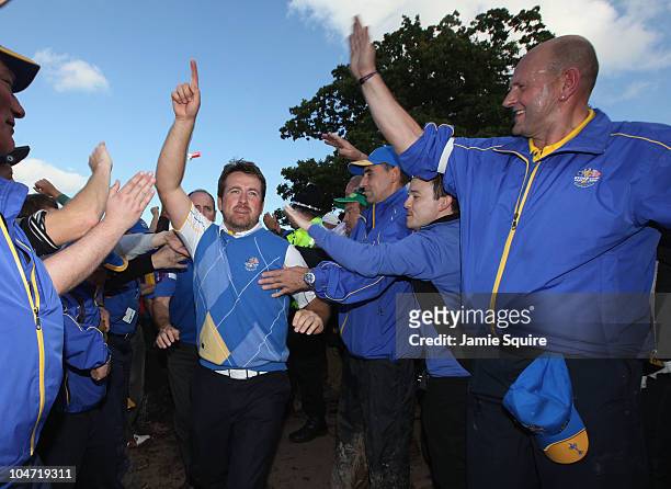 Graeme McDowell of Europe celebrates his 3&1 win to secure victory for the European team at the end of the singles matches during the 2010 Ryder Cup...