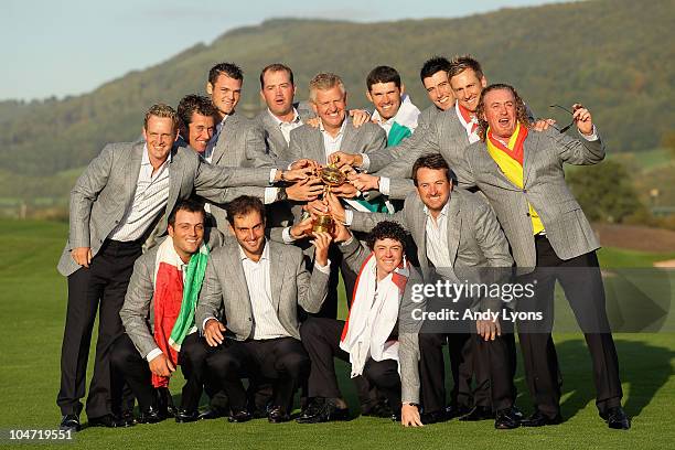 European Team Captain Colin Montgomerie poses with the Ryder Cup and his team following Europe's 14.5 to 13.5 victory over the USA at the 2010 Ryder...