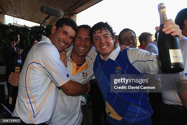 Padraig Harrington, Sergio Garcia and Rory McIlroy of Europe celebrate on the balcony of the clubhouse following Europe's victory in the 2010 Ryder...