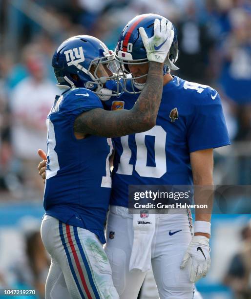 Odell Beckham Jr thanks teammate Eli Manning of the New York Giants for the touchdown pass against the Carolina Panthers in the fourth quarter during...