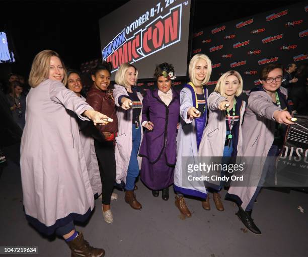 Fans dressed as Doctor Who characters pose during BBC America's Doctor Who Global Premiere at New York Comic Con on October 7, 2018 in New York City.
