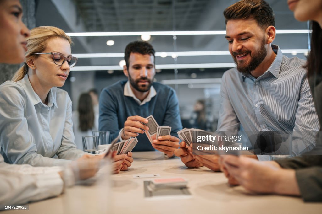 Business colleagues playing cards on a break in the office.