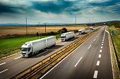 Caravan or convoy of White Lorry trucks on highway