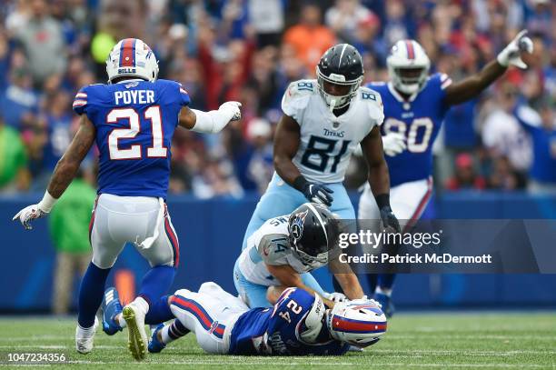 Cornerback Taron Johnson of the Buffalo Bills is tackled by wide receiver Nick Williams of the Tennessee Titans after catching an interception in the...