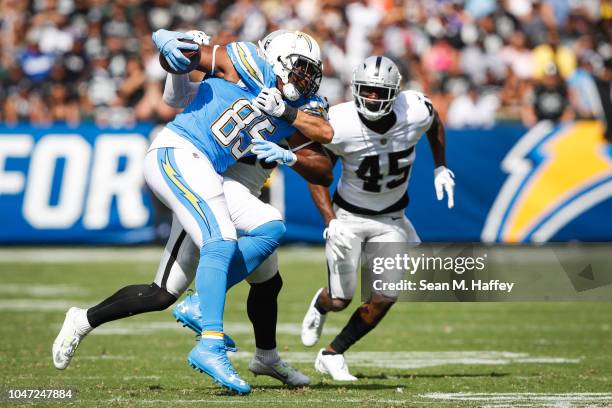 Tight end Antonio Gates of the Los Angeles Chargers runs with the ball in front of defensive back Dominique Rodgers-Cromartie of the Oakland Raiders...