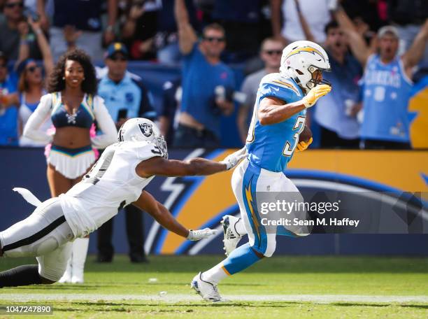 Running back Austin Ekeler of the Los Angeles Chargers scores a touchdown in the second quarter in front of strong safety Marcus Gilchrist of the...