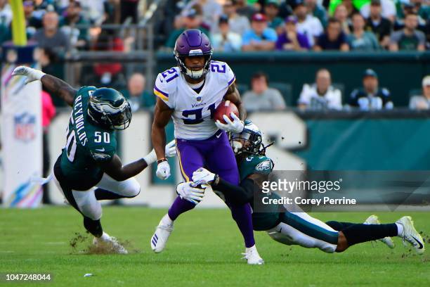 Cornerback Mike Hughes of the Minnesota Vikings is tackled by runs the ball against linebacker LaRoy Reynolds and cornerback Avonte Maddox of the...