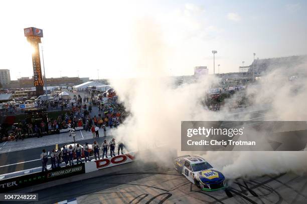 Chase Elliott, driver of the NAPA Auto Parts Chevrolet, celebrates winning the Monster Energy NASCAR Cup Series Gander Outdoors 400 at Dover...